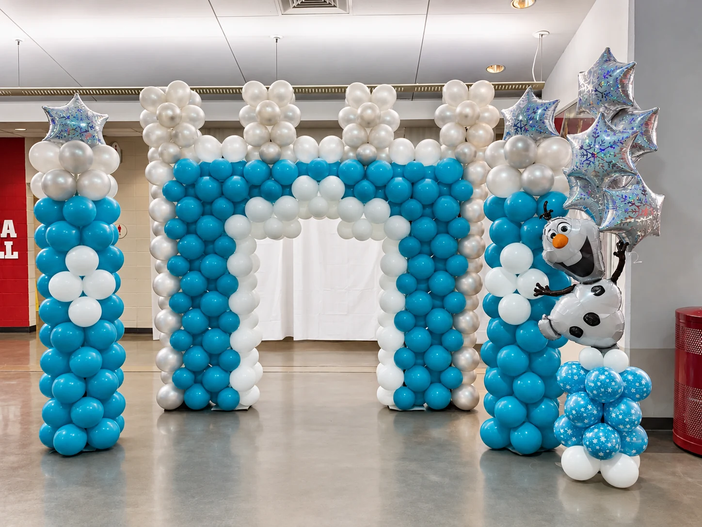 Blue and white ice-princess balloon entrance with character sculpture