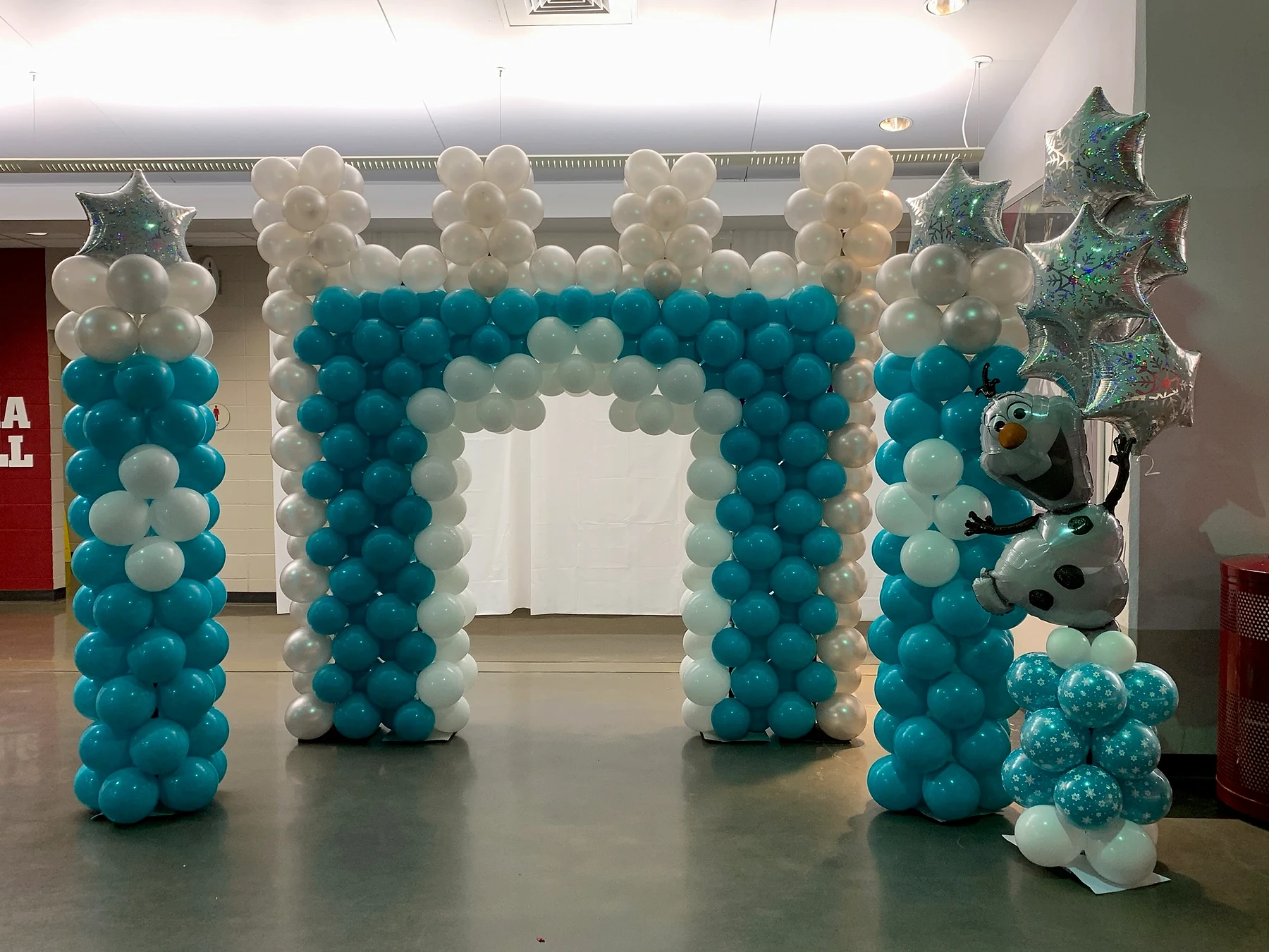 Ice-princess themed blue and white balloon arch