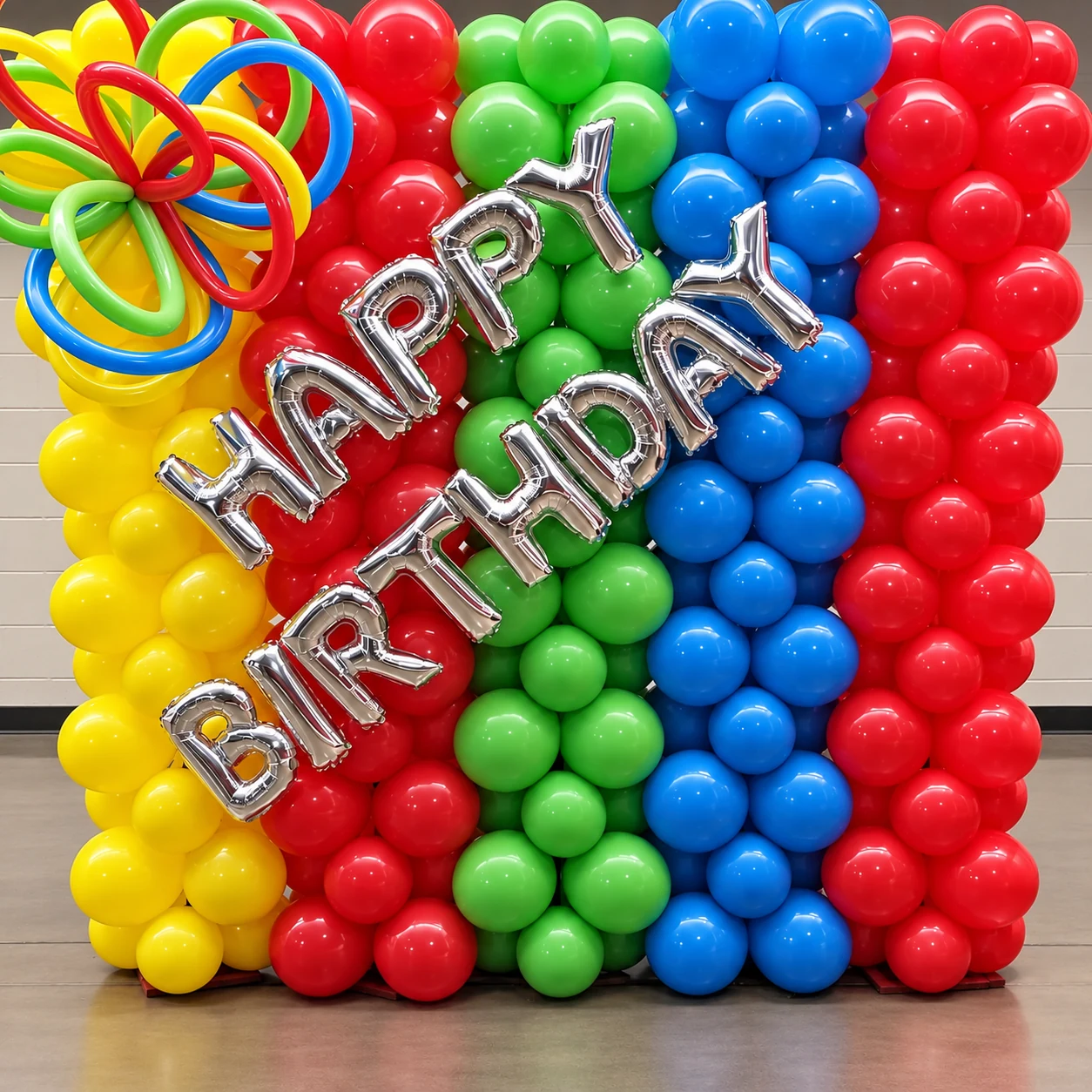 Colorful Happy Birthday balloon wall created by Artistic Balloon Co