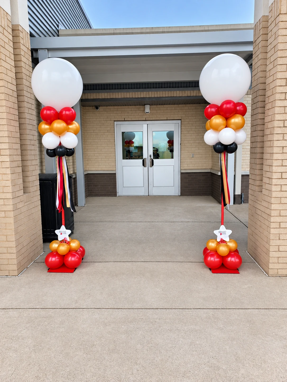 Pair of playful character balloon columns at an entrance