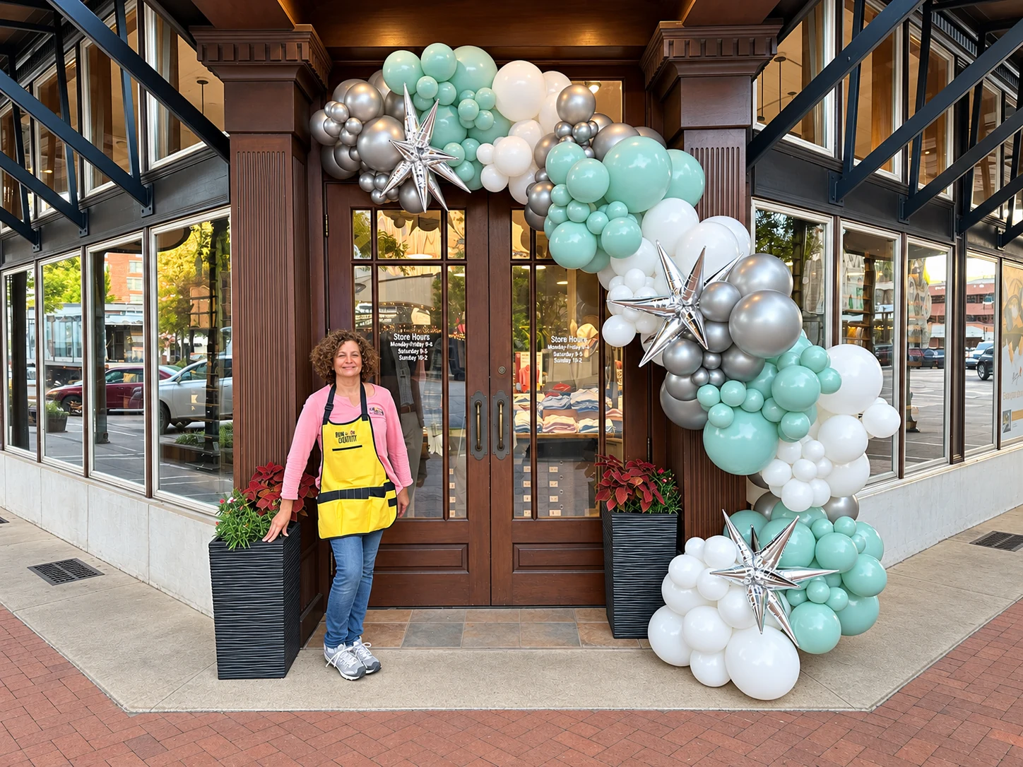 Mint, white and silver organic balloon garland at a storefront doorway