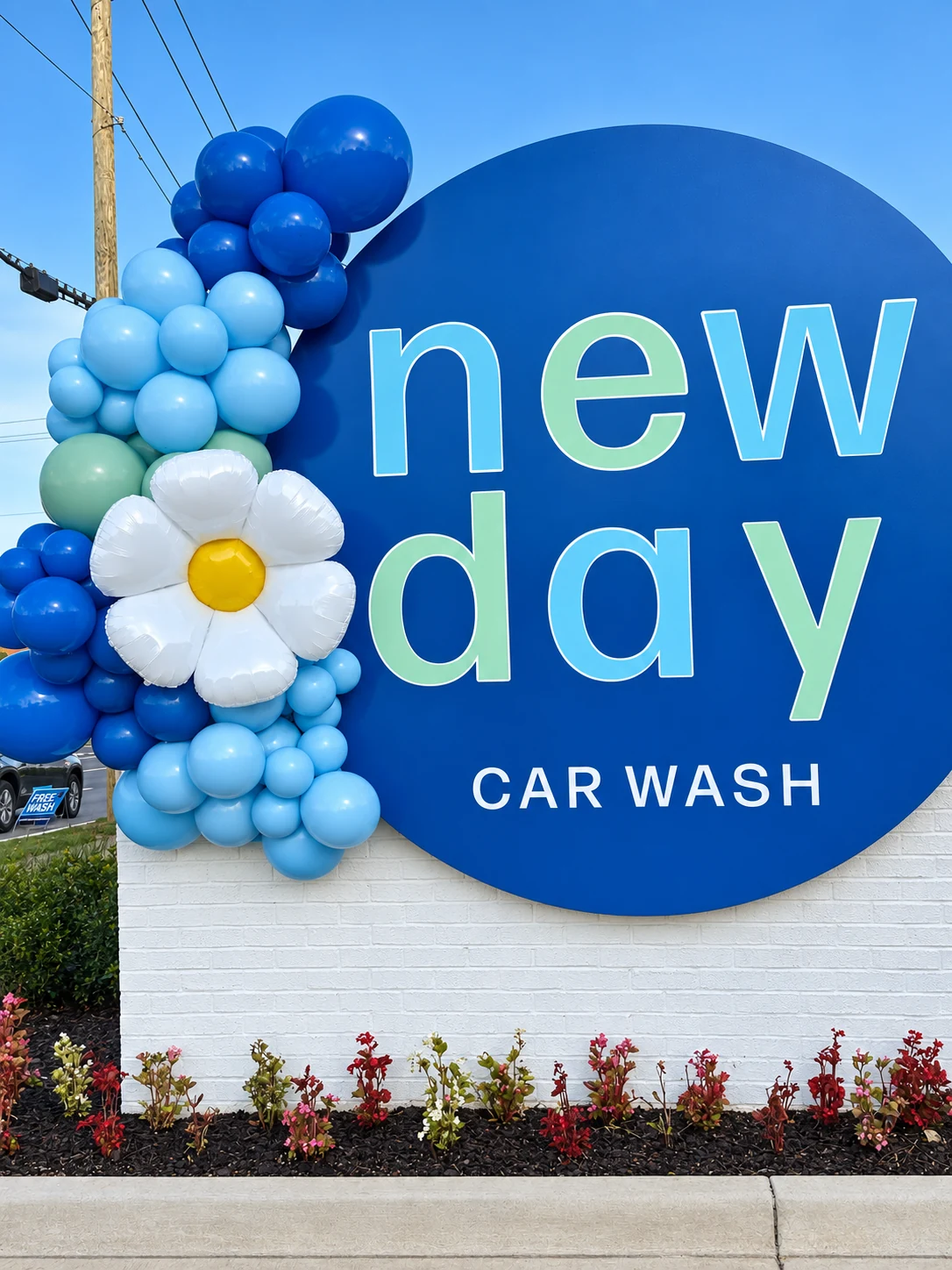 Blue and white organic balloon garland decorating a business sign