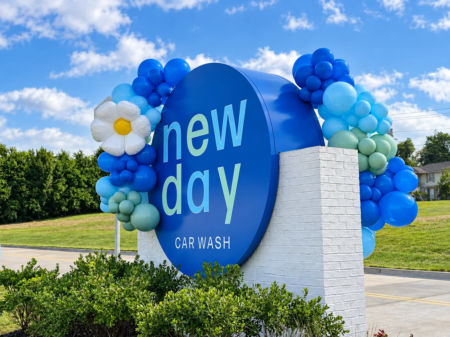 Blue and white business sign balloon garland viewed from the street