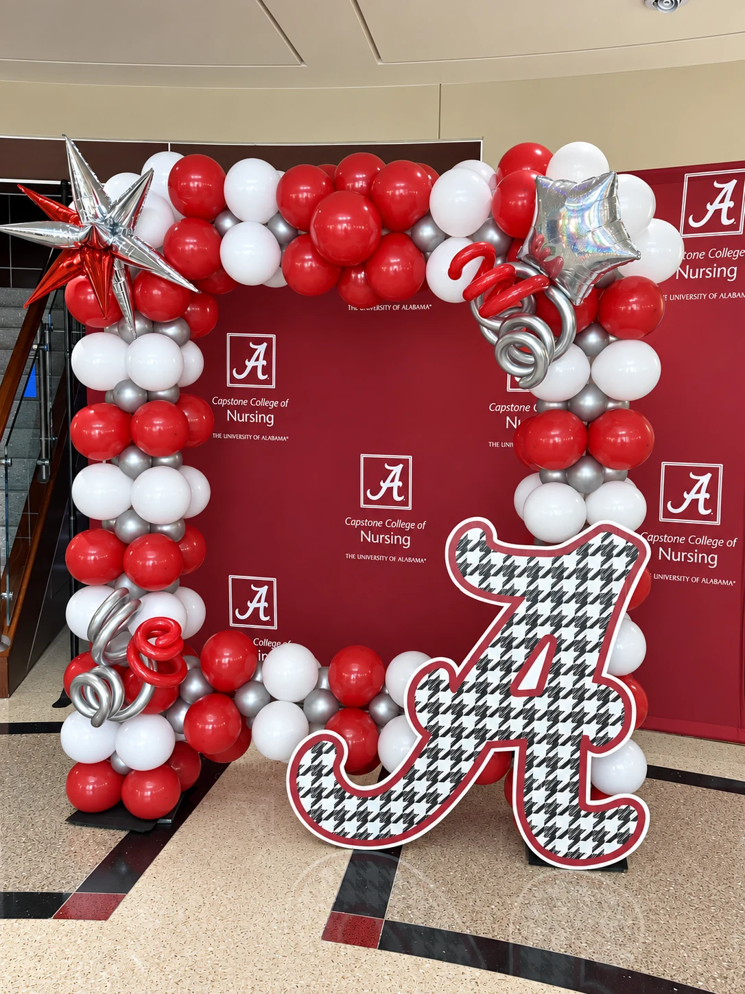 Crimson, white and silver university logo balloon wall