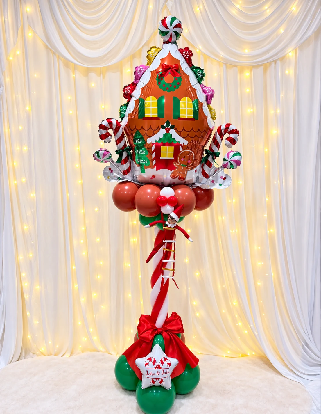 Holiday gingerbread balloon sculpture on a festive pedestal