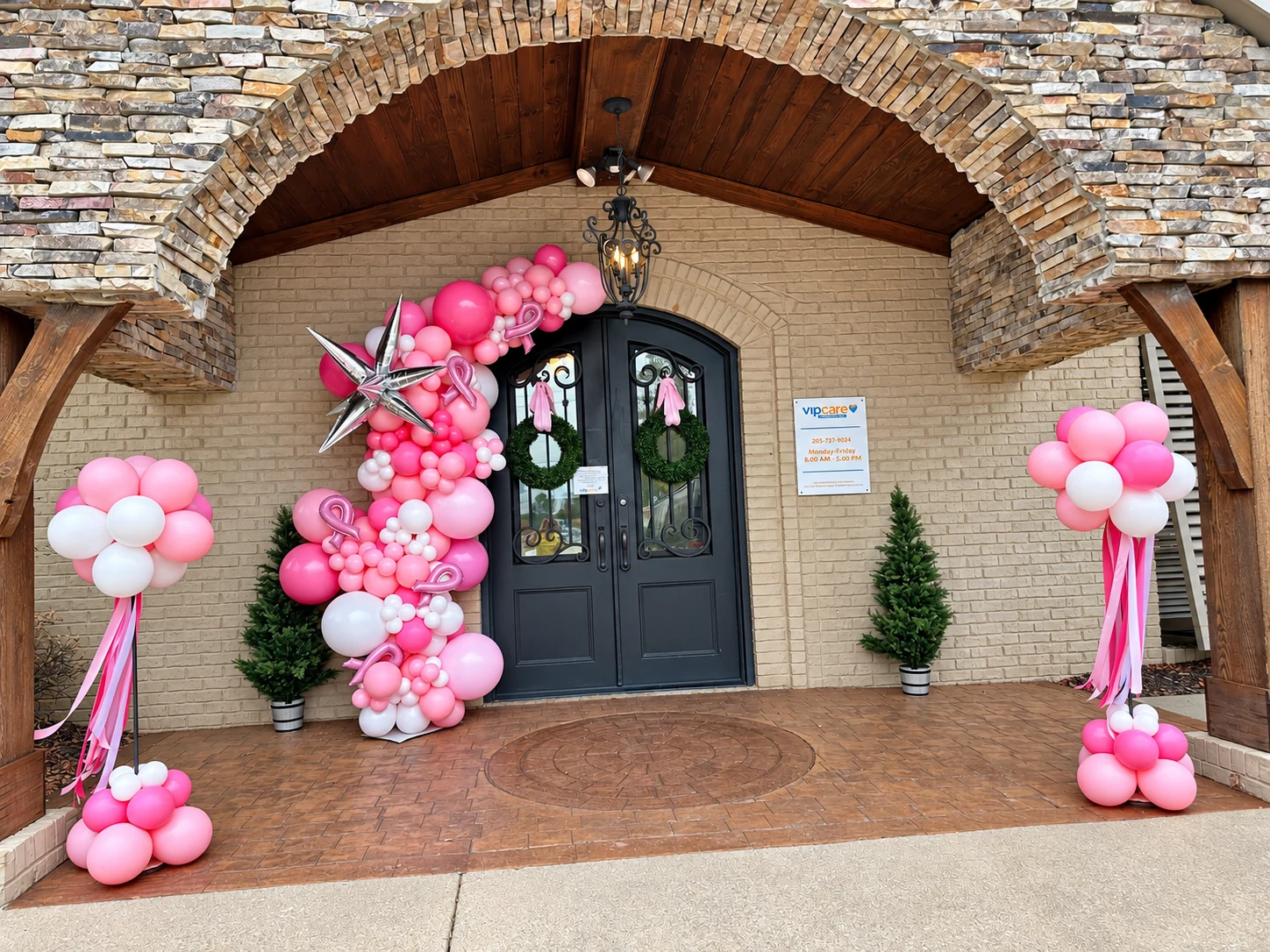 Pink organic doorway garland with coordinating balloon columns