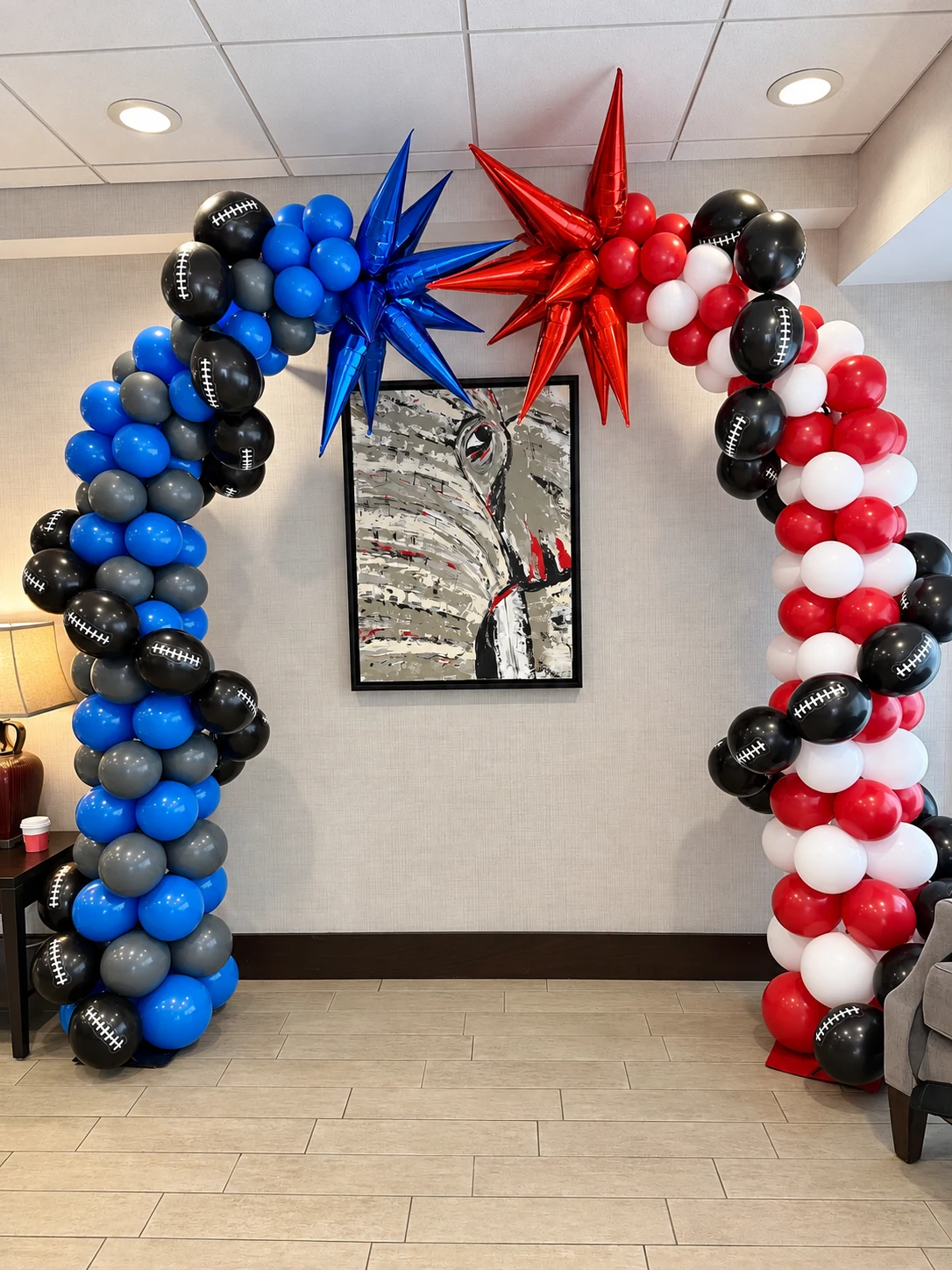 Red, white, blue and black double balloon arch with starbursts