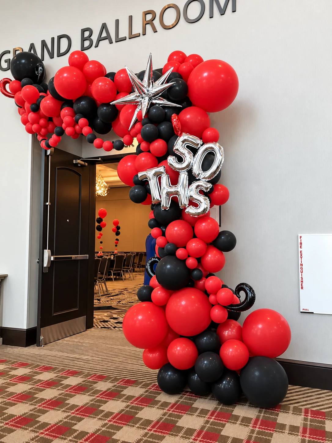 Red and black 50th birthday entrance balloon garland