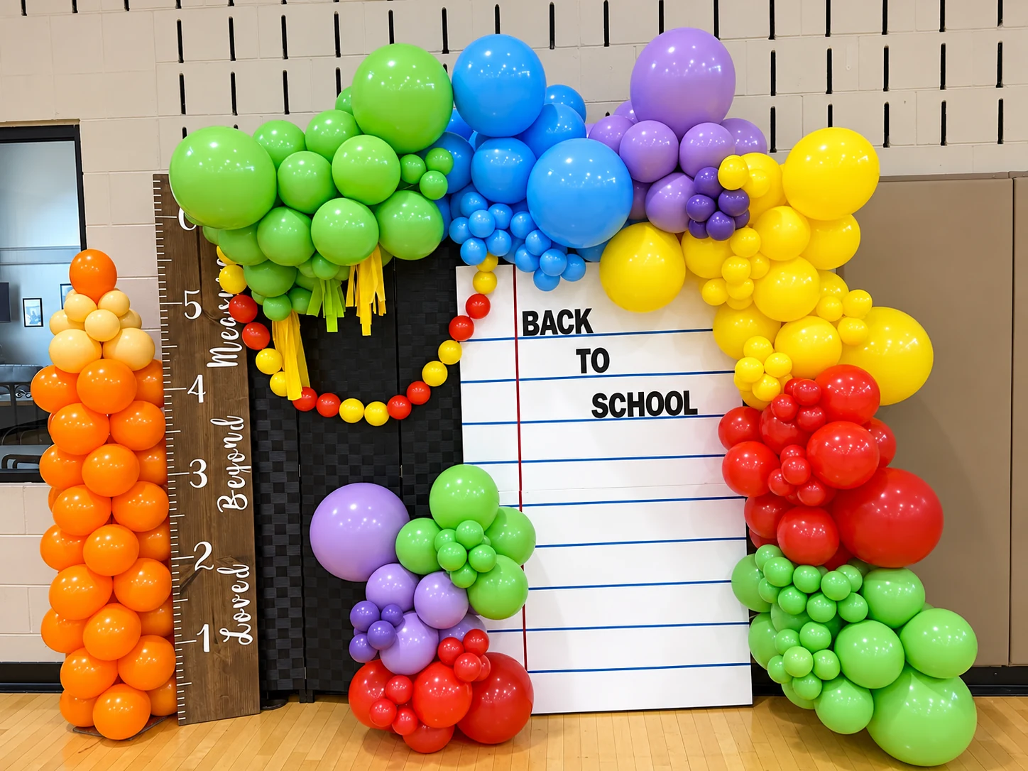 Rainbow back-to-school balloon photo area with height chart