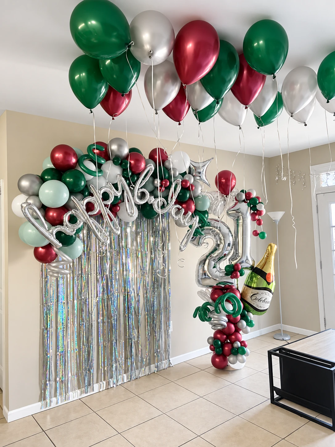 Happy New Year balloon backdrop with ceiling balloons and a champagne sculpture