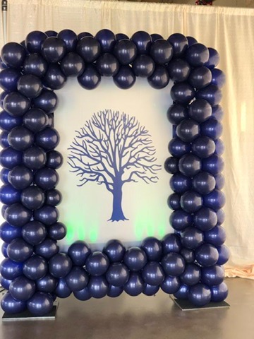 Navy balloon photo frame surrounding a tree design
