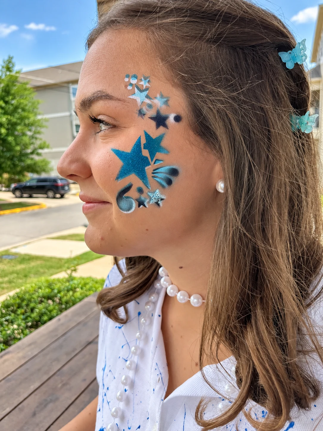 Blue star face-painting design with silver accents