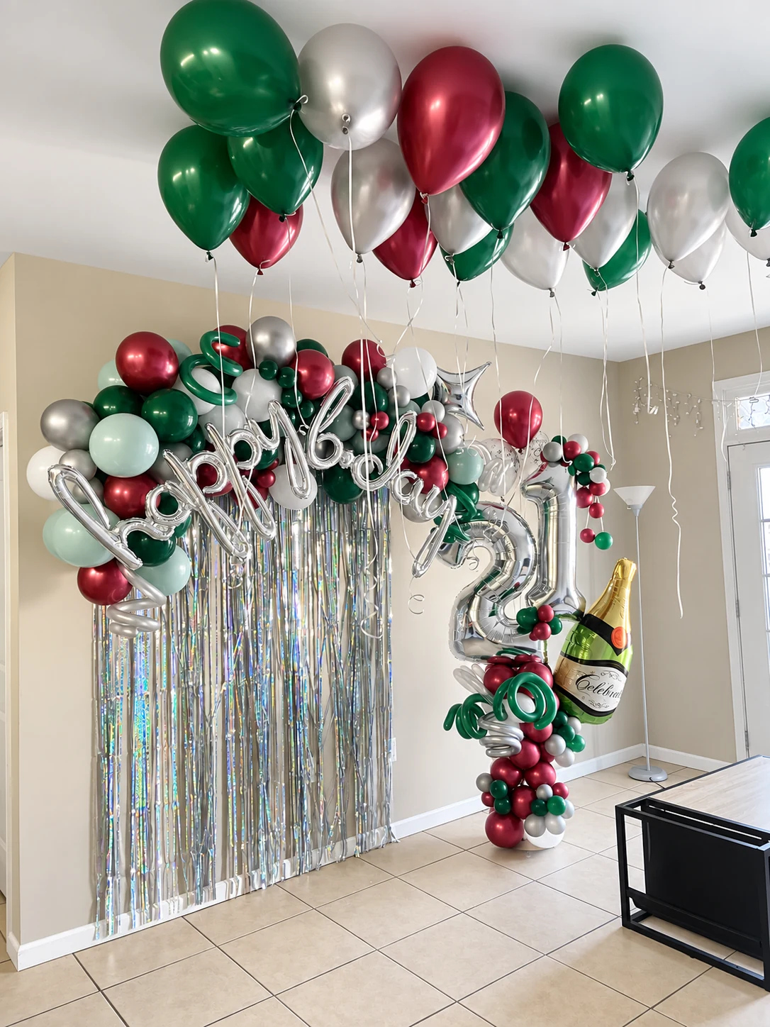Happy New Year balloon backdrop with floating ceiling balloons and champagne sculpture