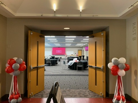 Pair of red, white and silver balloon columns at an event entrance