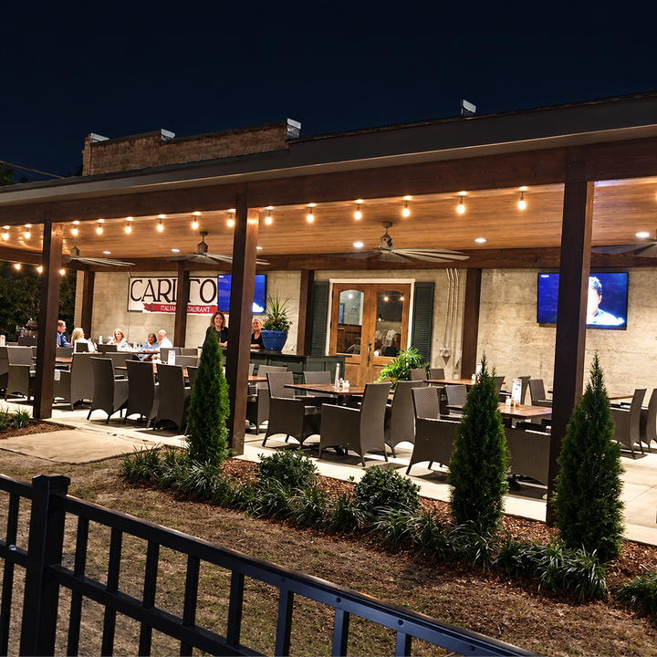 Lucy’s On 3rd patio illuminated at night